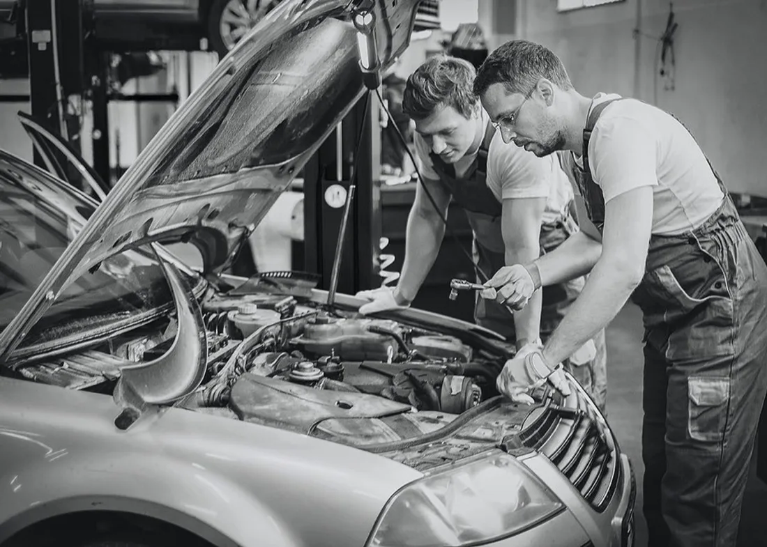 Mechanics at Auto Hospital 2 inspecting a vehicle's engine